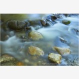 Silky Water and Shiny Rocks Stock Image