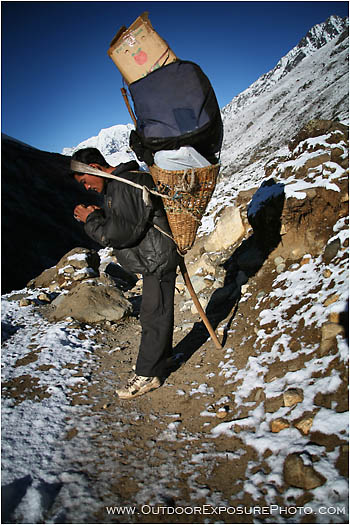 Rights Managed Stock Image: Porter With A Towering Load