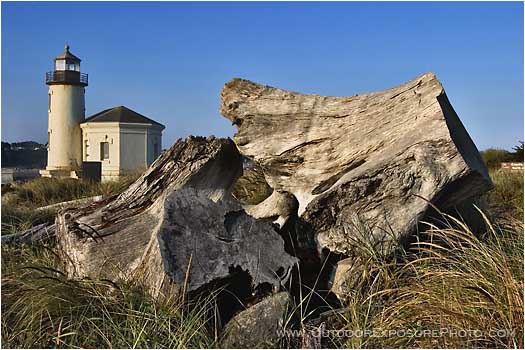 Royalty Free Stock Photo: Coquille River Lighthouse and Driftwood